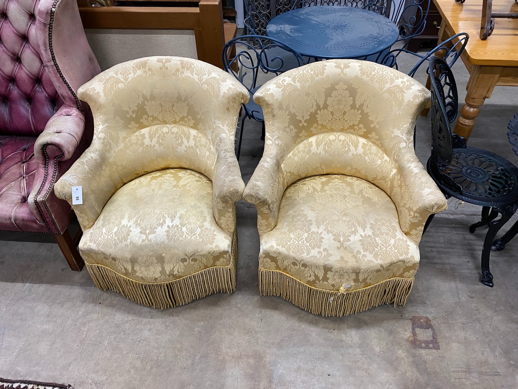 A pair of late Victorian upholstered tub framed armchairs